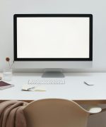 Stylish workspace with computer and simple furniture