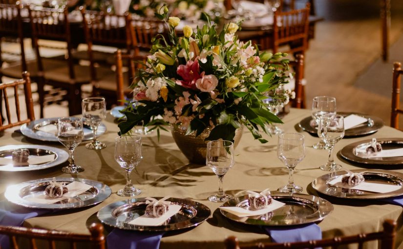 A table set for a wedding reception with flowers