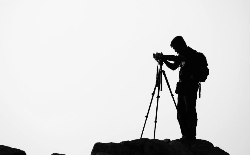 Silhouette of Man Holding Camera